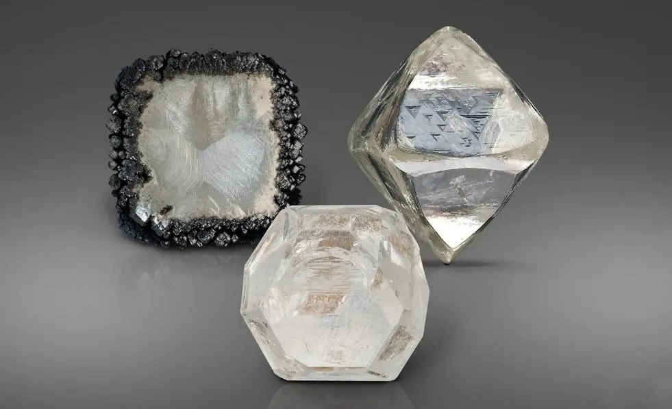 CVD-grown rough diamonds, HPHT-grown rough diamonds, and natural rough diamonds: a display of three types of diamonds
